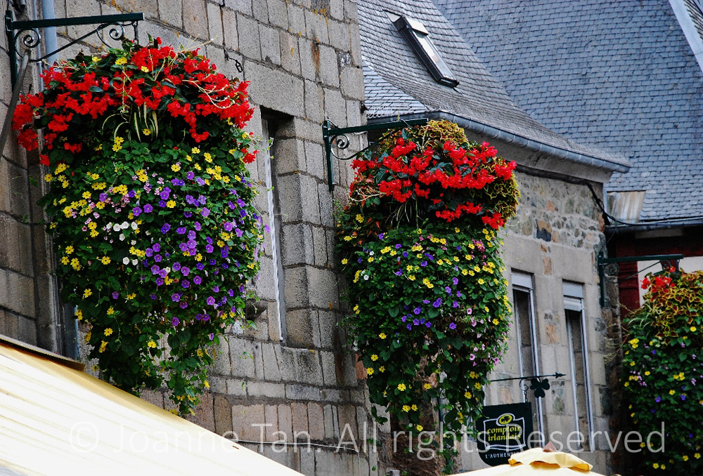 p- architecture - hanging baskets of flowers & stone buildings - Brittany, France
