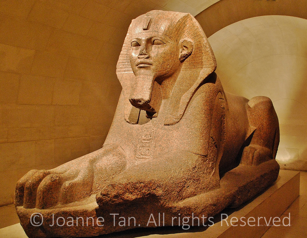Granite stone sculpture of an Egyptian tomb guard for the pyramid, androsphinx, full length. Pictured at the Louvre Museum, Paris, France.