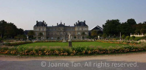 A French Mansion's rectangle garden in the back, lined with hedges, lawn in the center, statues, sculpture, terrace and walking path inside, outside, next to it.