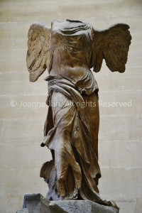 The full-length sculpture of the headless body of Goddess of Victory, spanning wings, at the Louvre Museum, Paris, France.